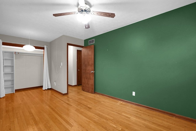 11831 Woodbridge Ln NW, Baltimore, OH 43105 - unfurnished bedroom featuring light wood-style floors, baseboards, a ceiling fan, and a closet