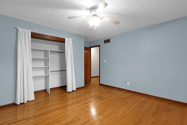 11831 Woodbridge Ln NW, Baltimore, OH 43105 - unfurnished bedroom featuring baseboards, light wood-style flooring, ceiling fan, and a textured ceiling