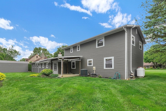 11831 Woodbridge Ln NW, Baltimore, OH 43105 - back of property featuring central AC unit, a patio area, and a yard