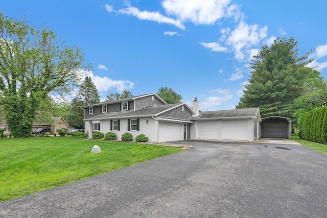 11831 Woodbridge Ln NW, Baltimore, OH 43105 - traditional home featuring a front lawn, a chimney, an attached garage, and asphalt driveway