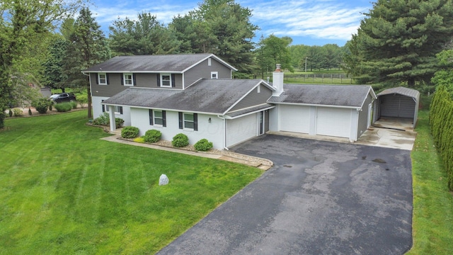 11831 Woodbridge Ln NW, Baltimore, OH 43105 - traditional-style house featuring an attached garage, a front lawn, asphalt driveway, a chimney, and a shingled roof