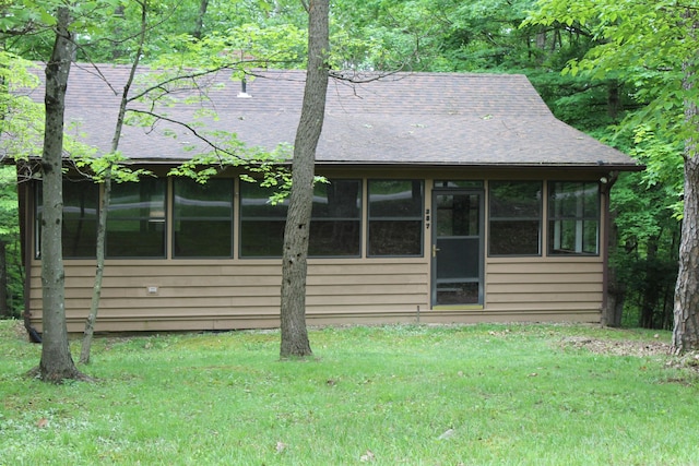 387 Mohican Ln, Sugar Grove, OH 43155 - view of front of home featuring a sunroom, a front lawn, and roof with shingles