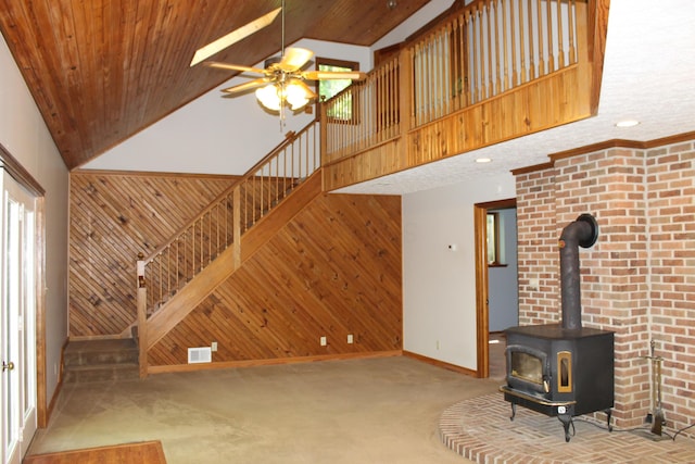 387 Mohican Ln, Sugar Grove, OH 43155 - unfurnished living room with high vaulted ceiling, carpet, a wood stove, baseboards, and ceiling fan