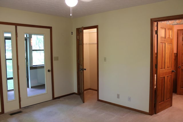 387 Mohican Ln, Sugar Grove, OH 43155 - unfurnished bedroom featuring light carpet, a walk in closet, baseboards, and a closet