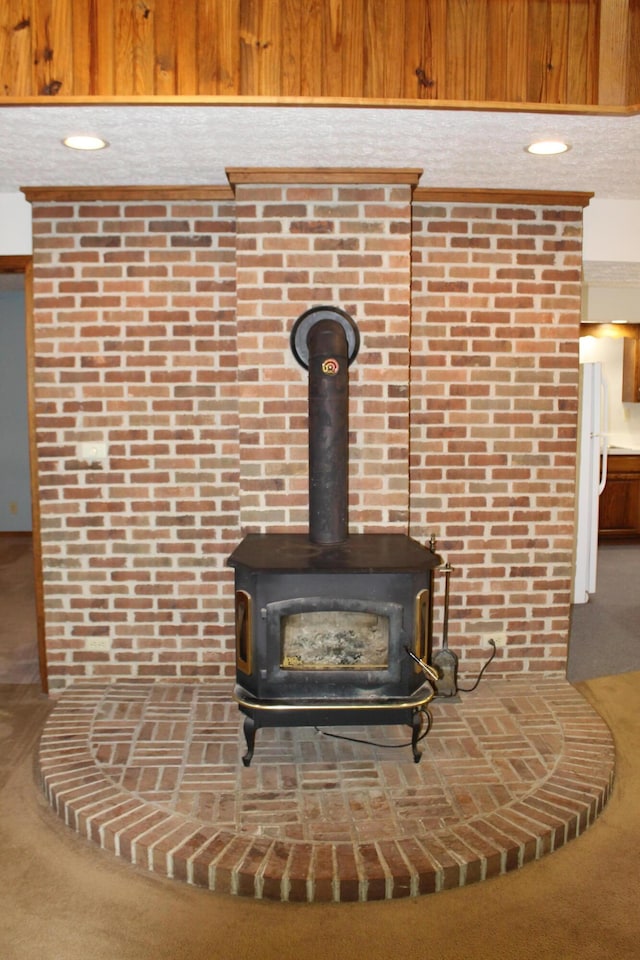 387 Mohican Ln, Sugar Grove, OH 43155 - detailed view of a wood stove, freestanding refrigerator, and carpet flooring