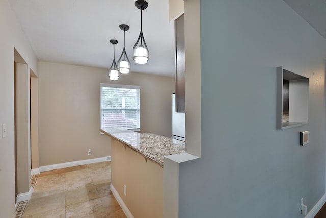 6219 Ambleside Dr, Columbus, OH 43229 - kitchen featuring decorative light fixtures, baseboards, and light stone countertops