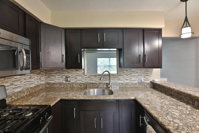 6219 Ambleside Dr, Columbus, OH 43229 - kitchen with black gas range oven, stainless steel microwave, a sink, and decorative backsplash