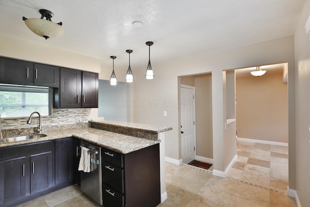 6219 Ambleside Dr, Columbus, OH 43229 - kitchen featuring a sink, stainless steel dishwasher, a peninsula, decorative backsplash, and light stone counters
