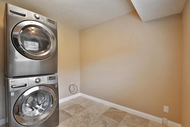 6219 Ambleside Dr, Columbus, OH 43229 - washroom featuring stacked washing machine and dryer and baseboards