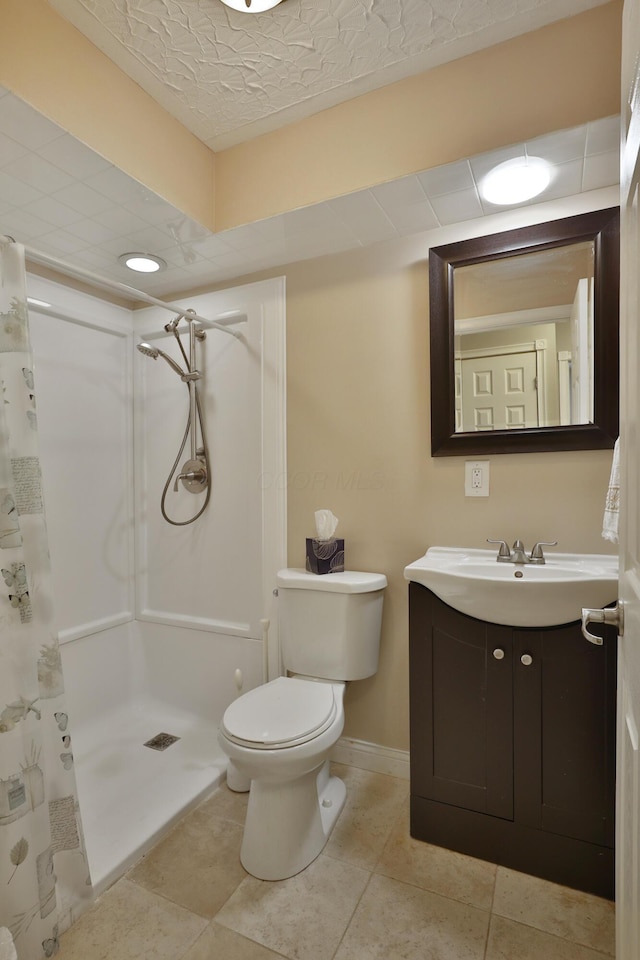 6219 Ambleside Dr, Columbus, OH 43229 - bathroom with toilet, vanity, curtained shower, and tile patterned floors