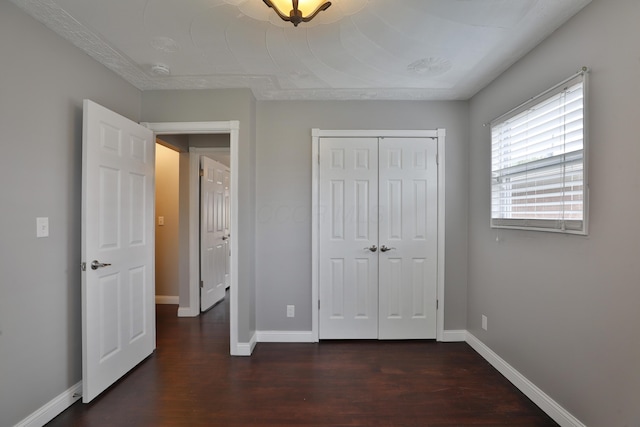 6219 Ambleside Dr, Columbus, OH 43229 - unfurnished bedroom with dark wood-style floors, baseboards, and a closet