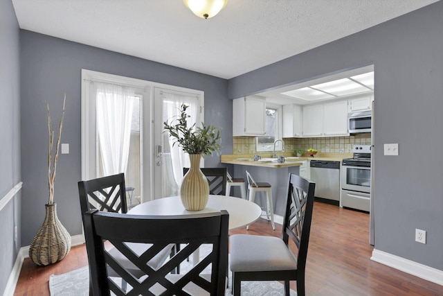 1755 Connors Point Dr, Columbus, OH 43220 - dining room with dark wood-style floors and baseboards