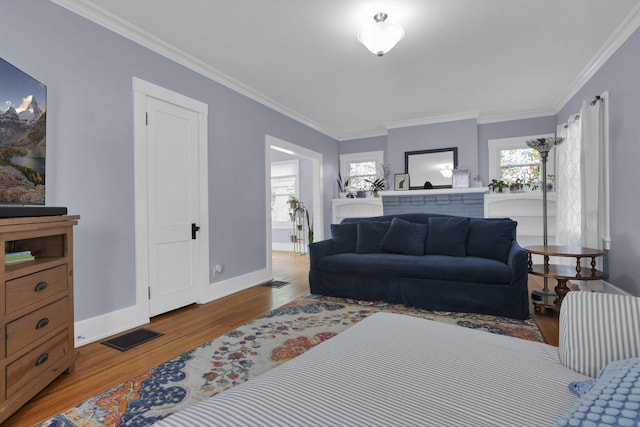 207 Jefferson Rd, Newark, OH 43055 - living area featuring wood finished floors, healthy amount of natural light, crown molding, baseboards, and a fireplace