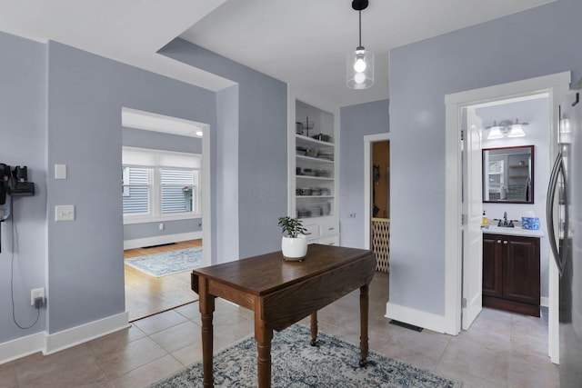 207 Jefferson Rd, Newark, OH 43055 - office area featuring built in shelves, light tile patterned floors, and baseboards