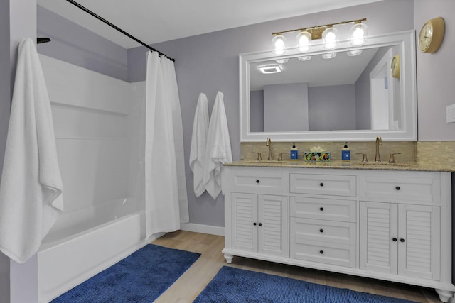 207 Jefferson Rd, Newark, OH 43055 - full bath featuring wood finished floors, double vanity, shower / tub combo with curtain, and backsplash