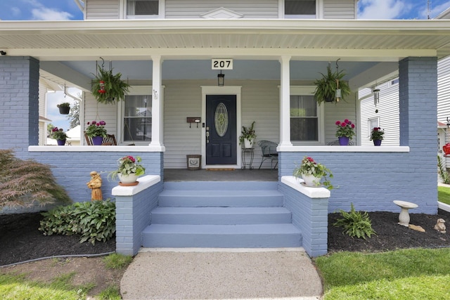 207 Jefferson Rd, Newark, OH 43055 - view of exterior entry featuring covered porch and brick siding