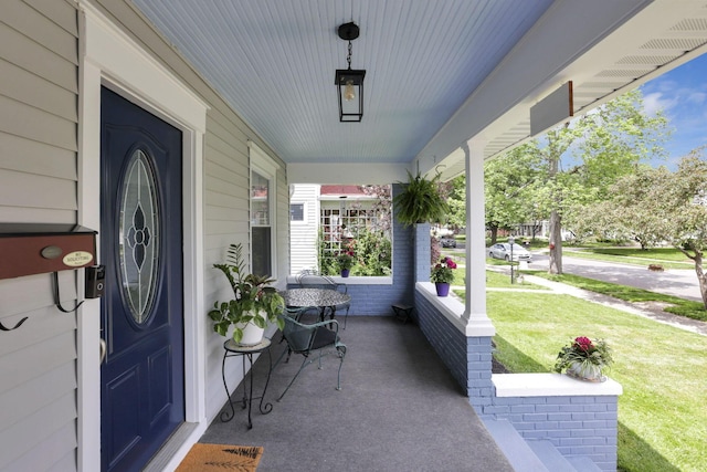 207 Jefferson Rd, Newark, OH 43055 - view of exterior entry with covered porch and a yard