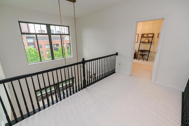 251 Daniel Burnham Sq Unit 703, Columbus, OH 43215 - hallway with carpet flooring, baseboards, and an upstairs landing