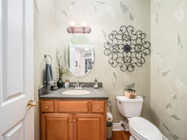 8171 Campden Lakes Blvd, Dublin, OH 43016 - half bath with toilet, vanity, and wood finished floors