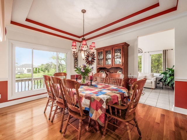 8171 Campden Lakes Blvd, Dublin, OH 43016 - dining room featuring a raised ceiling, plenty of natural light, a chandelier, and crown molding