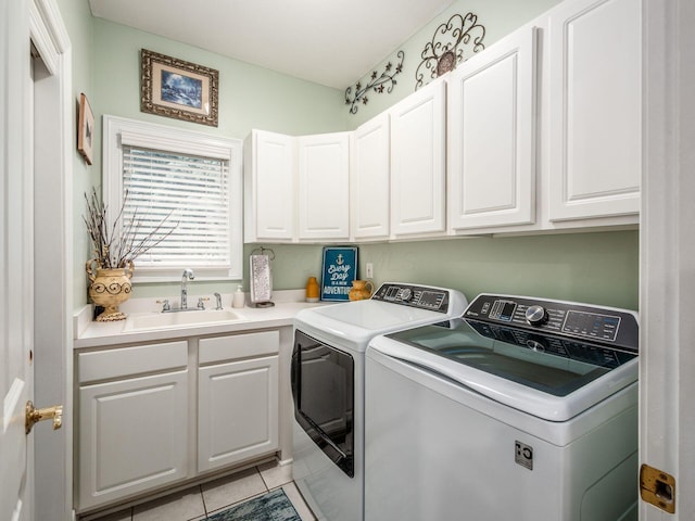 8171 Campden Lakes Blvd, Dublin, OH 43016 - laundry area featuring washing machine and dryer, cabinet space, and light tile patterned floors
