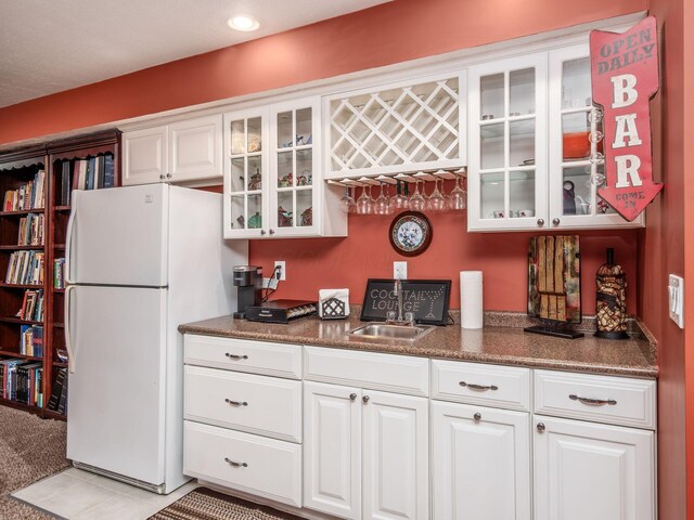 8171 Campden Lakes Blvd, Dublin, OH 43016 - kitchen with freestanding refrigerator, white cabinets, glass insert cabinets, a sink, and recessed lighting