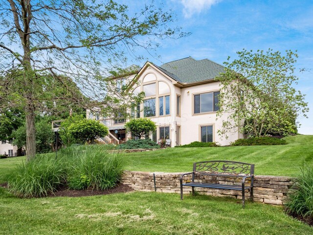 8171 Campden Lakes Blvd, Dublin, OH 43016 - rear view of property with stucco siding, a lawn, and a shingled roof