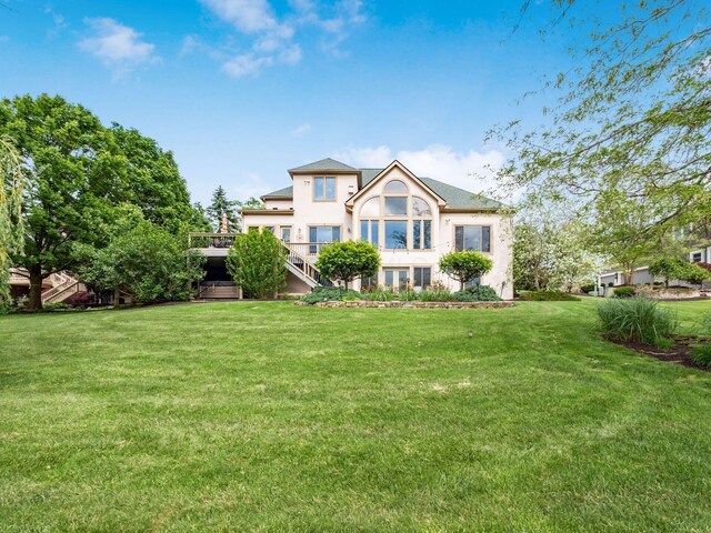 8171 Campden Lakes Blvd, Dublin, OH 43016 - view of front of house with a front yard, stairway, and stucco siding