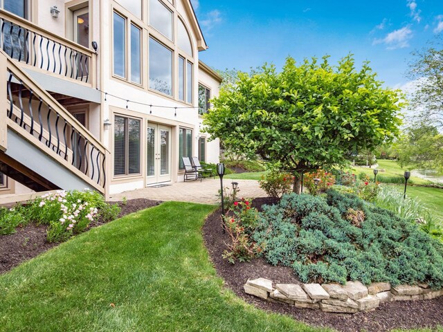 8171 Campden Lakes Blvd, Dublin, OH 43016 - view of grassy yard with french doors and a patio area