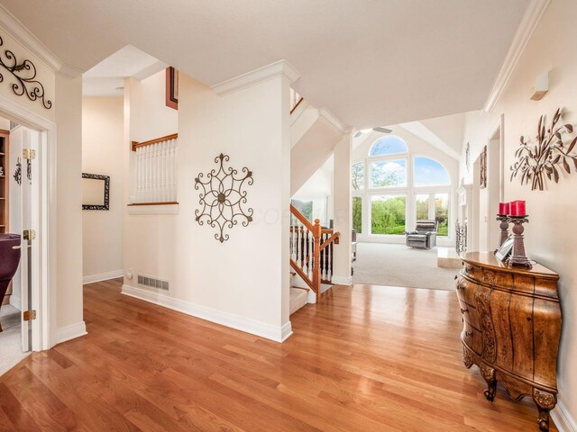 8171 Campden Lakes Blvd, Dublin, OH 43016 - hallway with ornamental molding, stairs, light wood-style floors, and baseboards