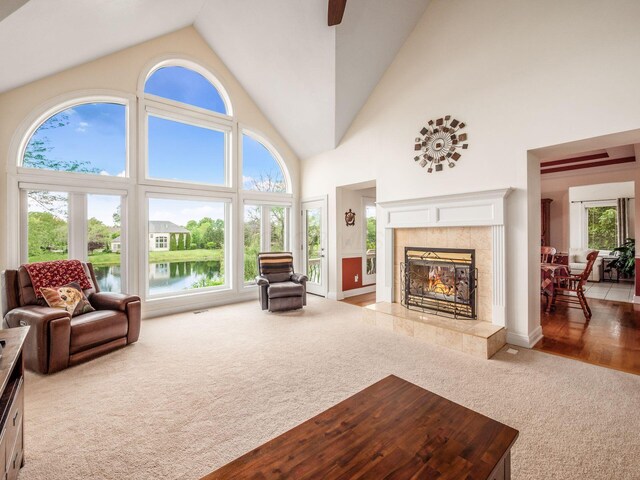 8171 Campden Lakes Blvd, Dublin, OH 43016 - carpeted living room with a water view, a fireplace, high vaulted ceiling, and ceiling fan