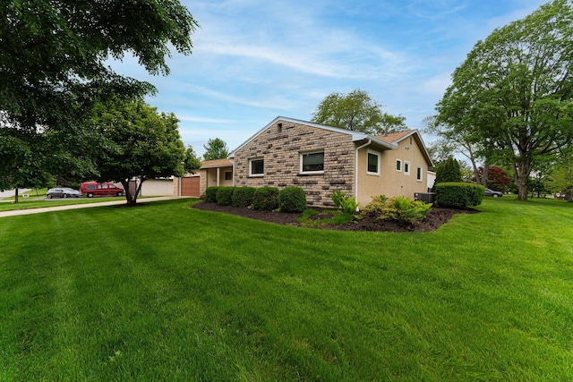 4015 Mountview Rd, Upper Arlington, OH 43220 - view of side of home with stone siding, a yard, stucco siding, and central AC