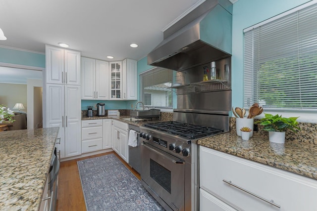 4015 Mountview Rd, Upper Arlington, OH 43220 - kitchen with high end range, wall chimney exhaust hood, white cabinetry, wood finished floors, and glass insert cabinets