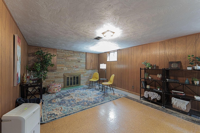 4015 Mountview Rd, Upper Arlington, OH 43220 - living area featuring tile patterned floors, wooden walls, a textured ceiling, and a fireplace