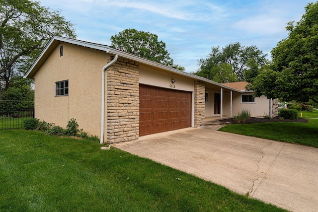 4015 Mountview Rd, Upper Arlington, OH 43220 - view of front of house with stone siding, a garage, stucco siding, and driveway