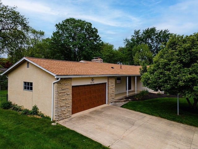 4015 Mountview Rd, Upper Arlington, OH 43220 - single story home with stone siding, an attached garage, a front yard, and stucco siding