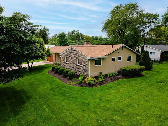 4015 Mountview Rd, Upper Arlington, OH 43220 - view of property exterior with a chimney, stone siding, a garage, and driveway