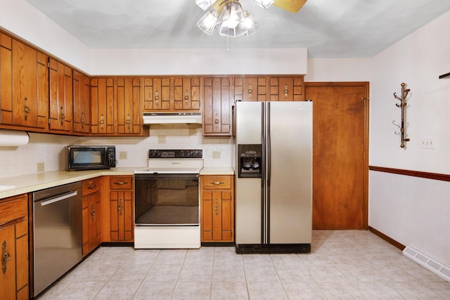 2580 Applewood Ln NE, Lancaster, OH 43130 - kitchen featuring stainless steel appliances, under cabinet range hood, and brown cabinets