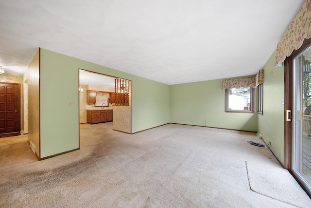 2580 Applewood Ln NE, Lancaster, OH 43130 - unfurnished living room featuring light carpet, baseboards, and a sink