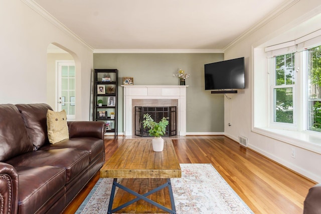 2008 N Edgemont Rd, Upper Arlington, OH 43212 - living area featuring wood finished floors, ornamental molding, arched walkways, baseboards, and a fireplace with flush hearth