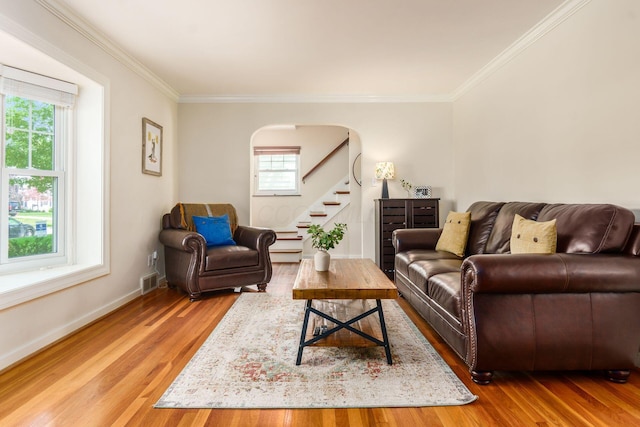 2008 N Edgemont Rd, Upper Arlington, OH 43212 - living room featuring healthy amount of natural light, ornamental molding, wood finished floors, baseboards, and stairs