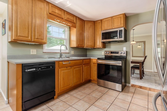 2008 N Edgemont Rd, Upper Arlington, OH 43212 - kitchen featuring stainless steel appliances, a sink, light countertops, ornamental molding, and light tile patterned floors
