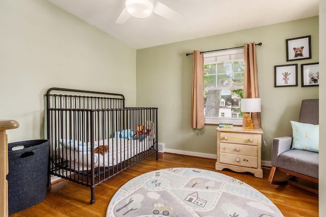 2008 N Edgemont Rd, Upper Arlington, OH 43212 - bedroom featuring wood finished floors, a crib, baseboards, and a ceiling fan