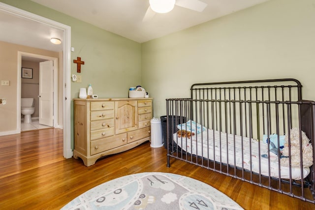 2008 N Edgemont Rd, Upper Arlington, OH 43212 - bedroom featuring wood finished floors, a crib, a ceiling fan, and baseboards