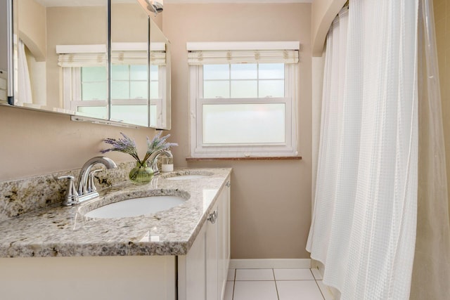 2008 N Edgemont Rd, Upper Arlington, OH 43212 - bathroom featuring healthy amount of natural light, double vanity, tile patterned floors, and baseboards