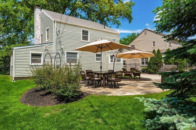 2008 N Edgemont Rd, Upper Arlington, OH 43212 - back of house featuring a chimney, a patio area, and a yard