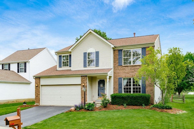 6249 Corley Dr, Dublin, OH 43016 - view of front of home with asphalt driveway, brick siding, and a front lawn