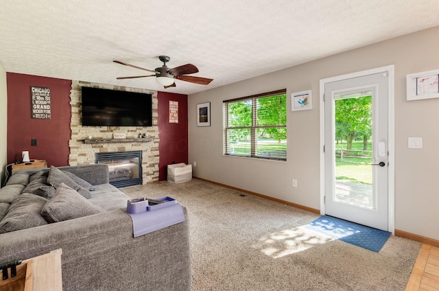 6249 Corley Dr, Dublin, OH 43016 - living area with baseboards, ceiling fan, a fireplace, and a textured ceiling