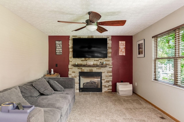 6249 Corley Dr, Dublin, OH 43016 - carpeted living room with a ceiling fan, a stone fireplace, plenty of natural light, a textured ceiling, and an accent wall