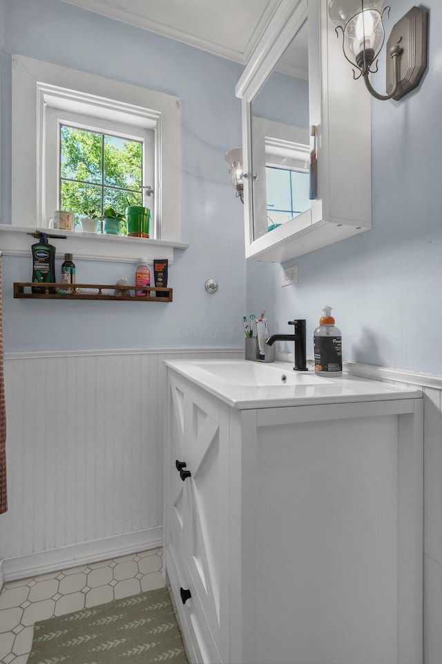 297 S James Rd, Columbus, OH 43213 - bathroom featuring tile patterned floors, healthy amount of natural light, vanity, and a wainscoted wall